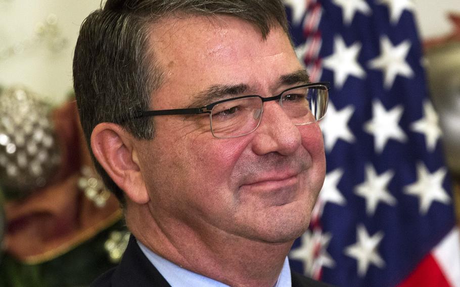 Ashton Carter listens as President Barack Obama announces his nomination as secretary of defense at the White House in December 2014.