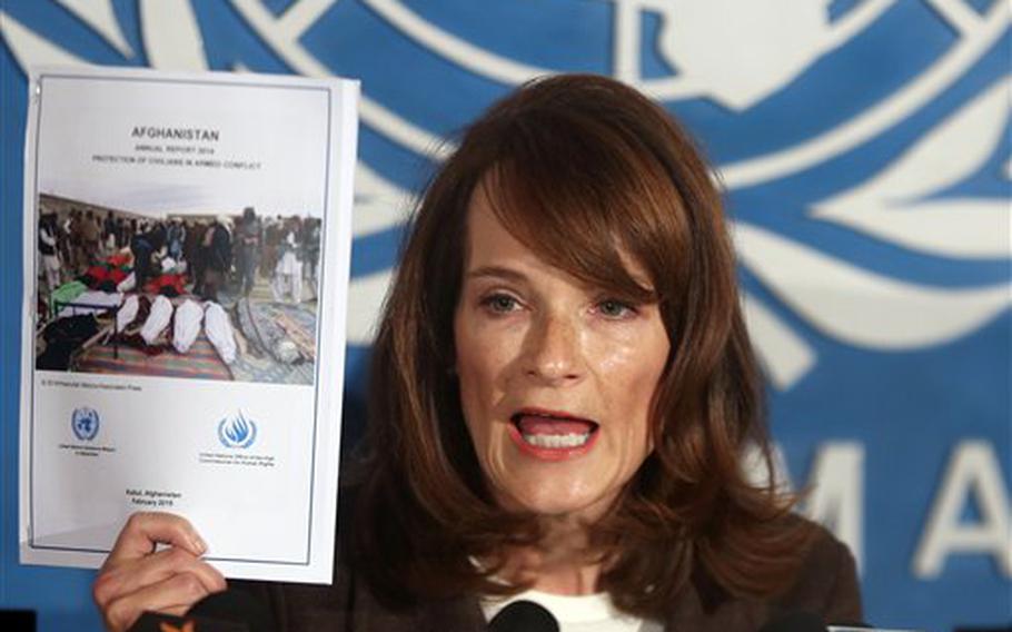 U.N. Human Rights Director Georgette Gagnon shows a copy of a report on civilian casualties in 2014 during a press conference in Kabul, Afghanistan, Wednesday, Feb. 18, 2015. In a separate report, released Wednesday, Feb. 25, 2015, the U.N. Assistance Mission in Afghanistan said more than one in three Afghans detained on conflict-related allegations say they were tortured or mistreated.