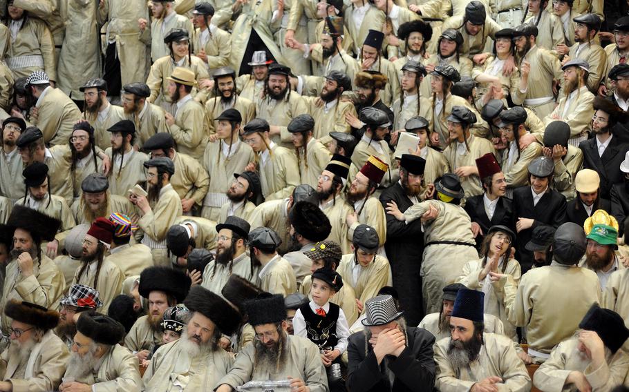 Gili Yaari, "Purim Holiday in Jerusalem1" | Ultra-Orthodox Jewish men of the Toldot Aharon Sect celebrate the Purim holiday in the ultra-orthodox Mea Shearim neighborhood in Jerusalem on March 17, 2014. The festival of Purim commemorates the rescue of Jews from a genocide in ancient Persia.