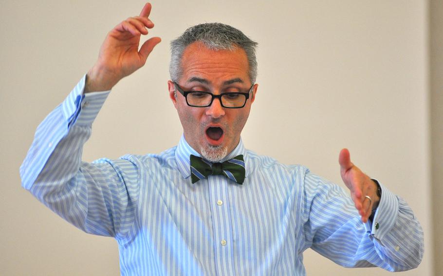 Mark Babcock, the guest choral conductor for the DODDS-Europe Honors Music Festival, sings while conducting during rehearsals Tuesday in Oberwesel, Germany.
                