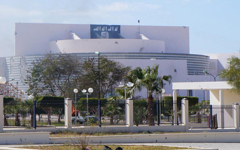 Islamic State fighters have made late Libyan leader Moammar Gadhafi's Ougadougou conference center in downtown Sirte, Libya, into their headquarters. This photos shows the Islamic State flag affixed to the center on March 11, 2015.