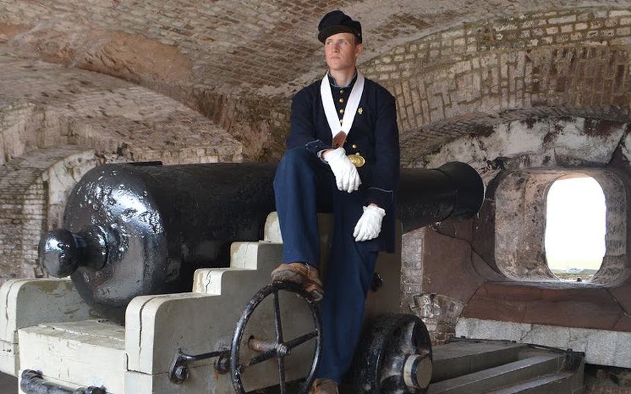 A reenactor sits on a canon at Fort Sumter after participating in the 150th anniversary of the re-raising of the American Flag over Fort Sumter at the end of the Civil War.