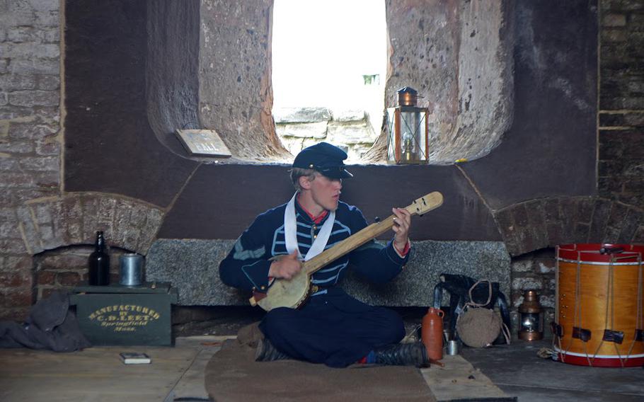 A re-enactor strums an instrument inside Fort Sumter on April 14, 2015. He was participating in events that marked the 150th anniversary of the re-raising of the American flag over the fort at the end of the Civil War.