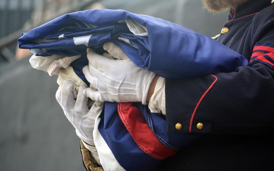 A reenactors inside Fort Sumter on April 14, 2015, holds a flag that was pulled out of a mail bag, which was how they transported the flag in 1865. He was participating in events that marked the 150th anniversary of the re-raising of the American flag over the fort at the end of the Civil War.