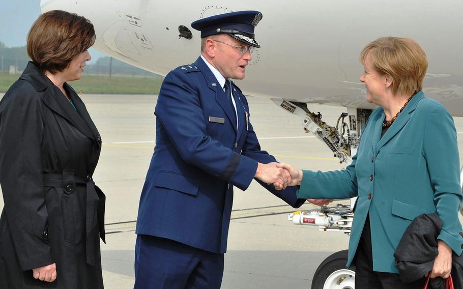 German Chancellor Angela Merkel is greeted by Maj. Gen. Andrew M. Mueller, E-3A Component commander, and his wife, Keri, during a short visit at NATO Air Base Geilenkirchen on April 30, 2014.