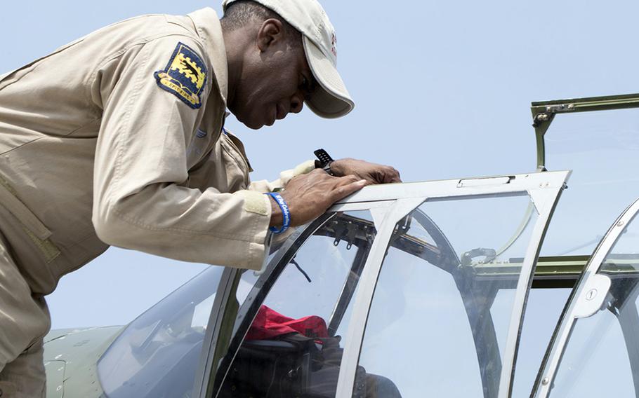 Brad Lang checks his plane at the Culpeper Regional Airport Thursday, May 7, during the preview for the Arsenal of Democracy: World War II Victory Capitol Flyover. Lang's father was a Tuskegee Airman at the end of World War II.