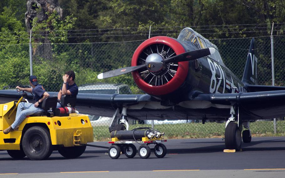 Two workers take a quick break while waiting for more planes to land at Culpeper Regional Airport Thursday, May 7, 2015.