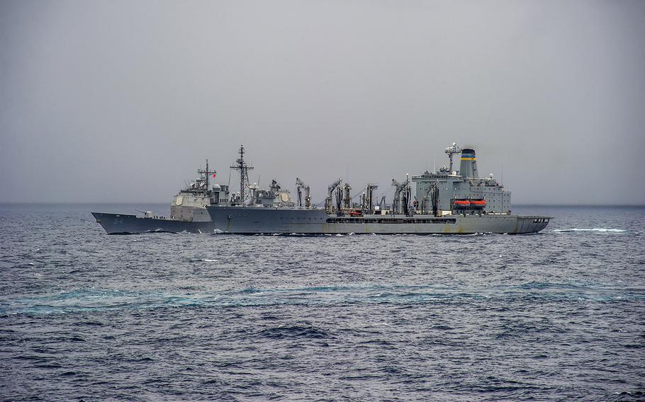The guided missile cruiser USS Antietam (CG 54), background, steams alongside the fleet replenishment oiler USNS Walter S. Diehl (T-AO 193) during a replenishment at sea in the South China Sea June 23, 2014.