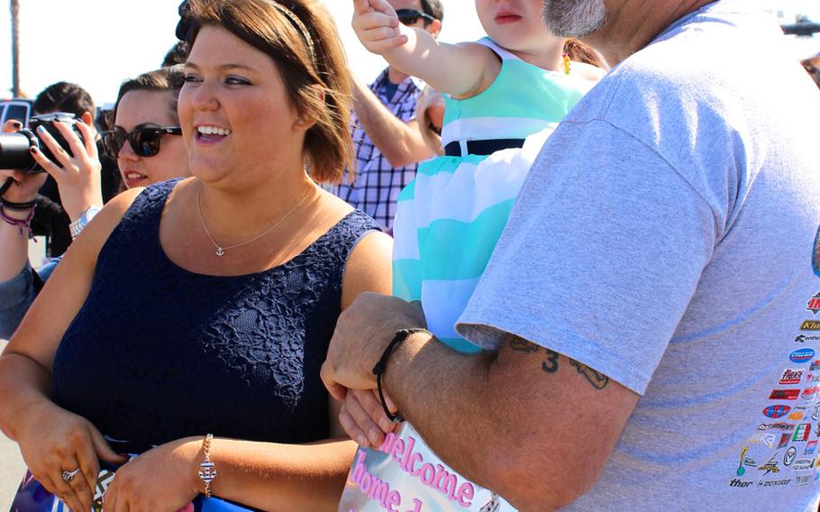 A family watches with glee as the USS Sampson comes into view at Naval Base San Diego on Monday morning, June 1, 2015. The ship was deployed for 7 months to the Asia-Pacific region.