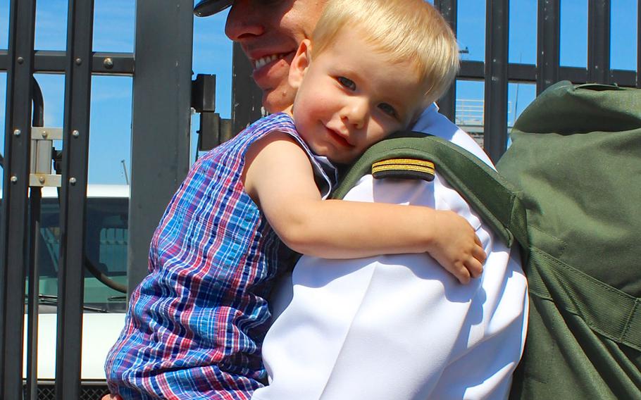 Seamus Walter, 2, cuddles with his daddy, Lt. Kevin Walter, after Kevin's return from a 7-month deployment aboard the USS Sampson. The ship visited several ports in the Western Pacific and helped in the search-and-recovery efforts for AirAsia flight 8501.