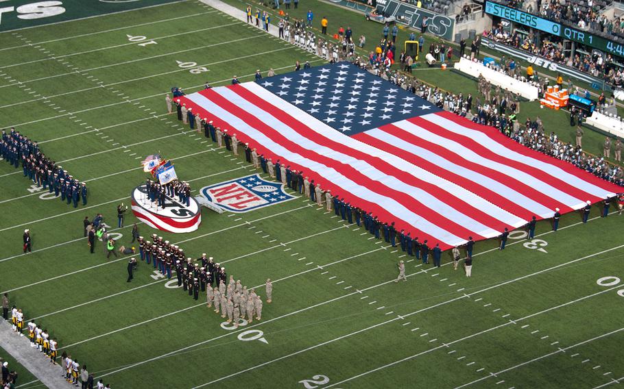 Servicemembers from all branches of the military sing the national anthem at MetLife Stadium in Rutherford, N.J., Nov. 9, 2014.