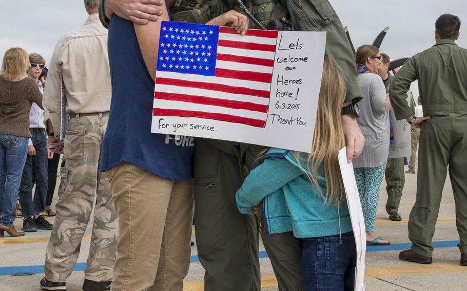 Lt. Cmdr. Trevor Hermann hugs his family members during a homecoming celebration at Naval Air Station North Island June 3, 2015, after returning from a 10-month deployment to the Western Pacific and Middle East. 
                