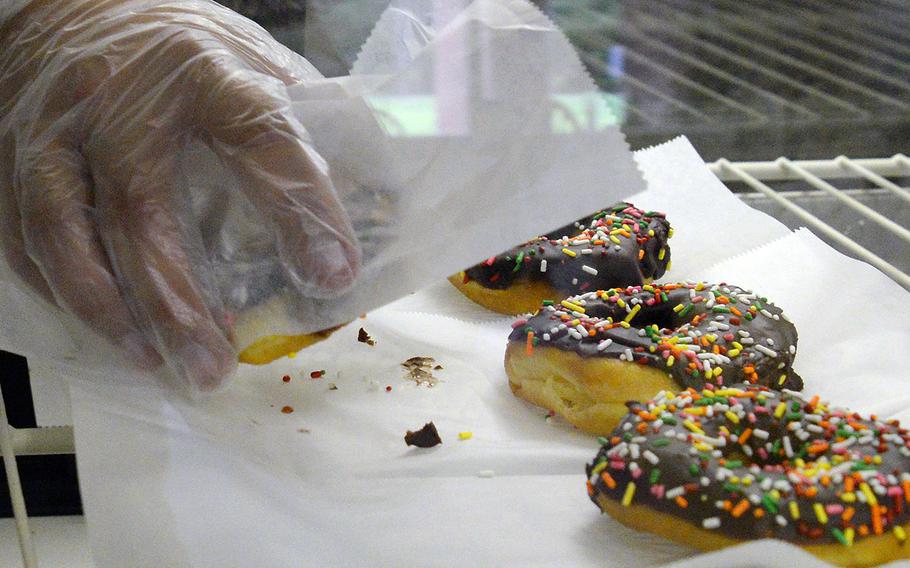 Doughnuts line a display shelf in a coffee shop in July 2014. 