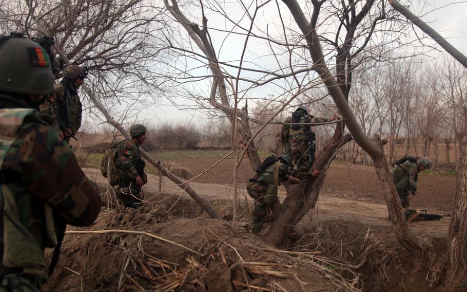 Afghan National Army commandos from the 5th Commando Kandak traverse a river crossing during a presence patrol in Archi district, Kunduz province, March 23, 2012. 