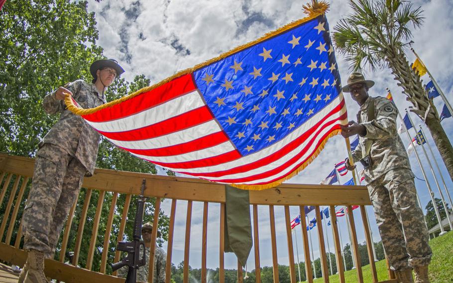 U.S. Army Reserve drill sergeants Maurice Tucker, of West Palm Beach, Fla., and Kristina Martinelli of Columbia, S.C. case the colors after a change of command ceremony at Fort Jackson, June 13, 2015.