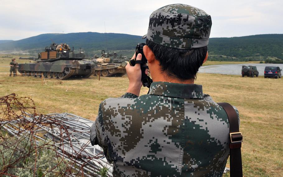 A member of the Chinese military photographs a U.S. Army M1A2 Abrams tank following a live-fire exercise that closed the Kabile 2015 tactical exercise at Novo Selo Training Area, Bulgaria, Thursday June 25, 2015. International military observers from Bosnia, Romania and Serbia were also seen at the demonstration. About 50 soldiers from 2nd Squadron, 2nd Cavalry Regiment and 3rd Combined Arms Battalion, 69th Armor Regiment took part in the exercise.