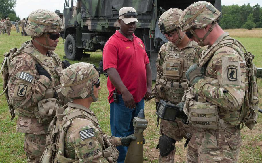 Patrick Stewart, the training instructor with Subsystems Technology, runs through the differences between the M1156 Precision Guidance Kit fuSe and the normal fuse these artillerymen from the 173rd Airborne Brigade Combat Team are used to. The artillerymen, along with counterparts from the 2nd Cavalry Regiment, were at Vilseck, Germany, testing the new fuse, July 23-24 and again on July 27-28.