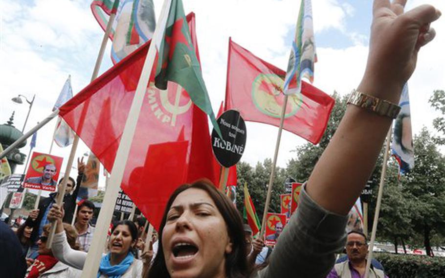 Kurdish demonstrators protest near Turkish Embassy in Paris, France, Monday, July 27, 2015, denouncing the deaths of 32 people in a suicide bombing last Monday, in Suruc, southeastern Turkey. Turkish warplanes struck Islamic State group targets across the border in Syria early Friday, in a strong tactical shift for Turkey which had long been reluctant to join the U.S.-led coalition against the extremist group.