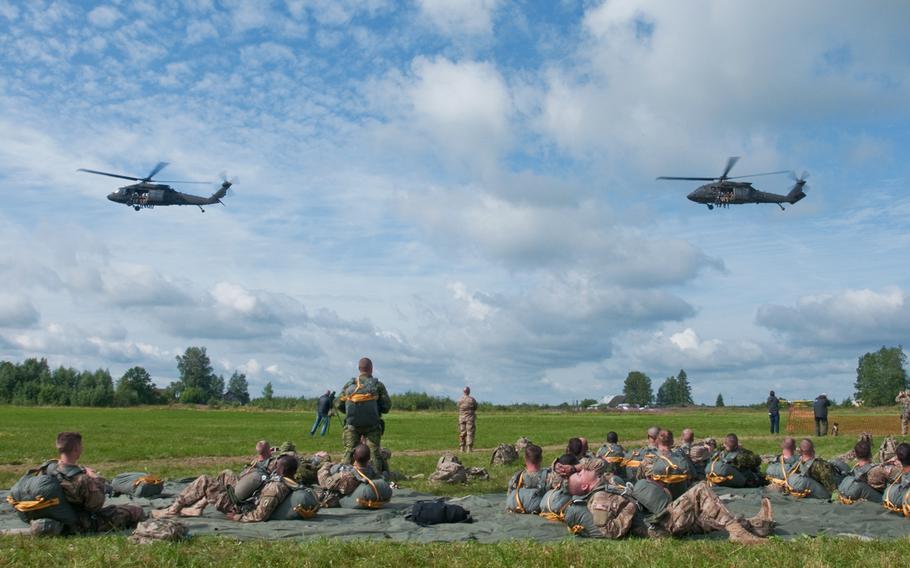 U.S. Army Aviation Soldiers with B Company, 4th Battalion, 3rd Aviation Brigade, 3rd Infantry Division, in their two UH-60m Black Hawk helicopters, depart from the loading area with chalks one and two July 23, 2015 at a drop zone in Nurmsi, Estonia.