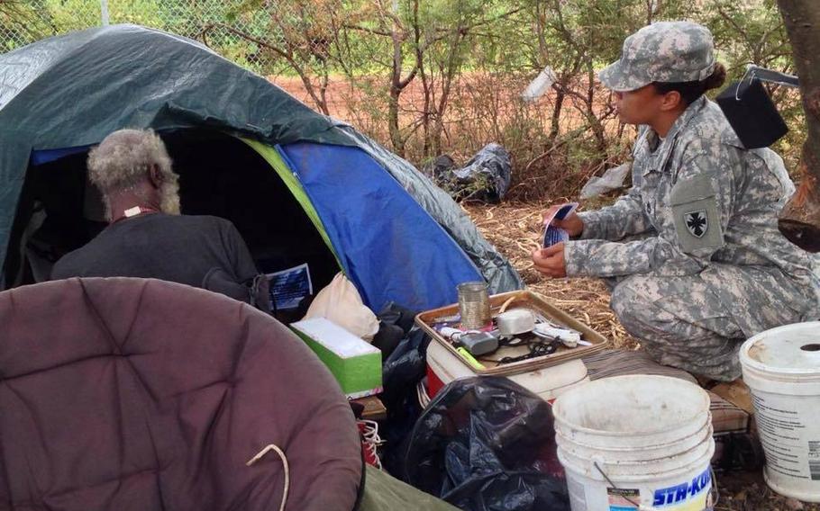 Sgt. 1st Class Nicole Howell talks with a homeless veteran about the upcoming 2015 Veterans Stand Down, Aug. 5, 2015. Troops separated from military service because of misconduct are far more likely to become homeless than other veterans, a new study has found.