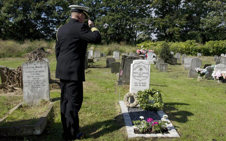 U.S. Navy Capt. Mark B. Rudesill, naval attache for the U.S. Embassy in London, salutes the newly installed grave marker of Maurice Wagg, a U.S. sailor buried in London who received the Medal of Honor. A ceremony was held on Thursday, Sept. 10, 2015. The U.S. Veterans Administration recently supplied a gravestone for Wagg.