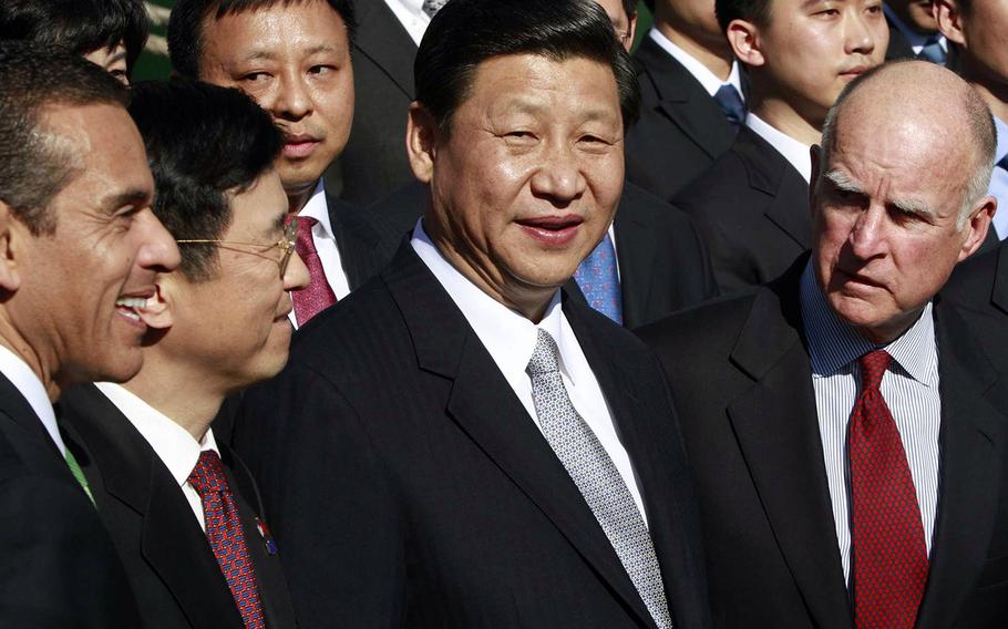 In a February, 2012 file photo, then-Vice President Xi Jinping of China, second from right, is shown with, left to right, Los Angeles Mayor Antonio Villaraigosa, China Shipping Chairman Li Shaode and California Gov. Jerry Brown at the harbor in Los Angeles.