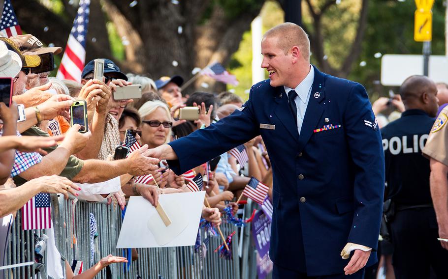 Airman 1st Class Spencer Stone greets the crowd during a parade in Sacramento, Calif., Sept. 11, 2015. Stone, one of three Americans who helped stop a terror attack on a Paris-bound train in August, was recuperating Thursday, Oct. 8, 2015, after having been repeatedly stabbed just after midnight in Sacramento.