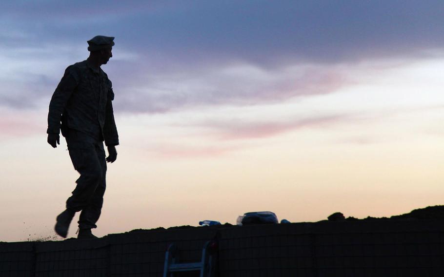 In a 2011 file photo, a U.S. soldier inspects defensive barriers in the Shorabak district of Kandahar province. The area has long been a stronghold and traditional homeland for the Taliban.