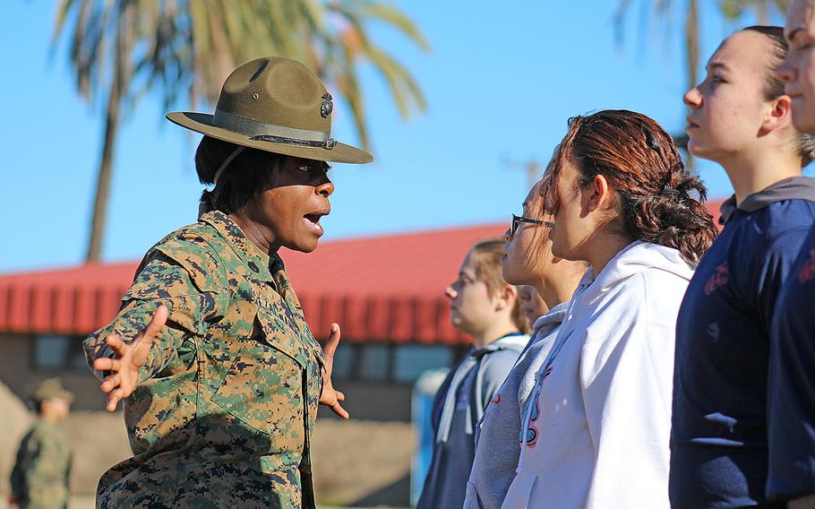 A Marine Corps drill instructor corrects a Marine enlistee on Dec. 12, 2015, during training at Marine Corps Base Camp Pendleton, Calif. In a Jan. 1, 2016, memo, Secretary of the Navy Ray Mabus instructed the Marine Corps to end gender-segregated initial training by April.