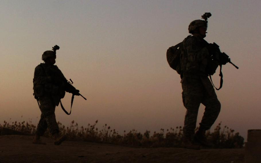 In a December, 2007 file photo, soldiers with the 2nd Battalion, 502nd Infantry Regiment, 2nd Brigade Combat Team, 101st Airborne Division (Air Assault), move toward an objective while searching for detonation cord after an improvised explosive device detonated near a bridge in Iskandariyah, Iraq.