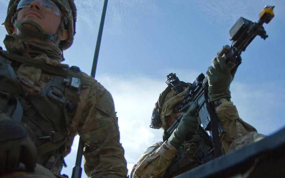National Guardsman Pfc. Devon Kobbe, left, and Sgt. Turner Masek, assigned to Troop A, 2nd 104th Cavalry Regiment, look for possible enemy movement during multinational training with their German and Lithuanian partners at the Great Lithuanian Hetman Jonusas Radvila Training Regiment in Rukla, Lithuania, on June 15, 2015.