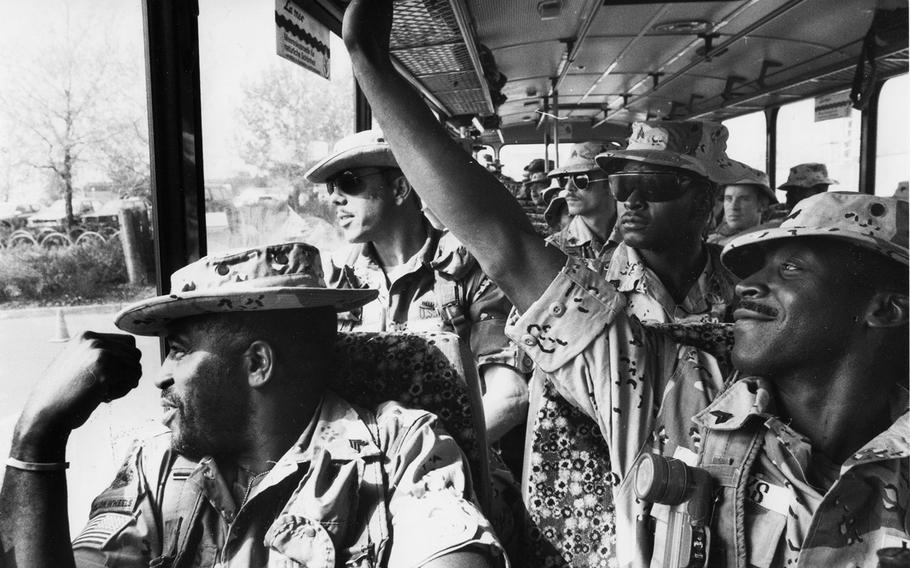 Soldiers returning from the Gulf War look for their loved ones as their bus pulls into the parking lot at Lucius D. Clay Casern in Garlstedt, Germany, in May, 1991. More than 1,000 U.S. servicemembers celebrated their homecoming that day.