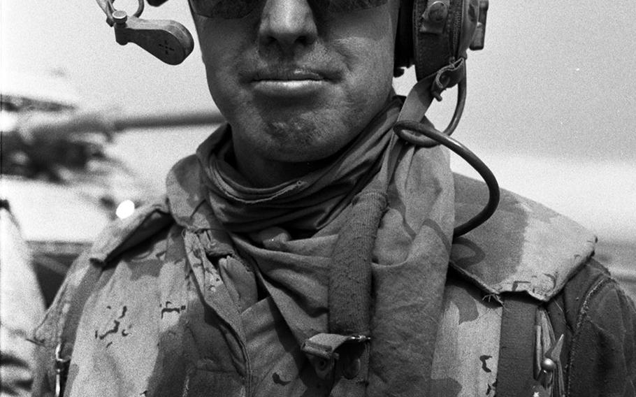 A Marine displays the colors during the drive toward Kuwait City in February, 1991.