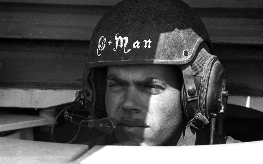 M1-A1 tank driver Spec. James Garman, 26, of Celina, Ohio, peers out from his position during the liberation of Kuwait in February, 1991.