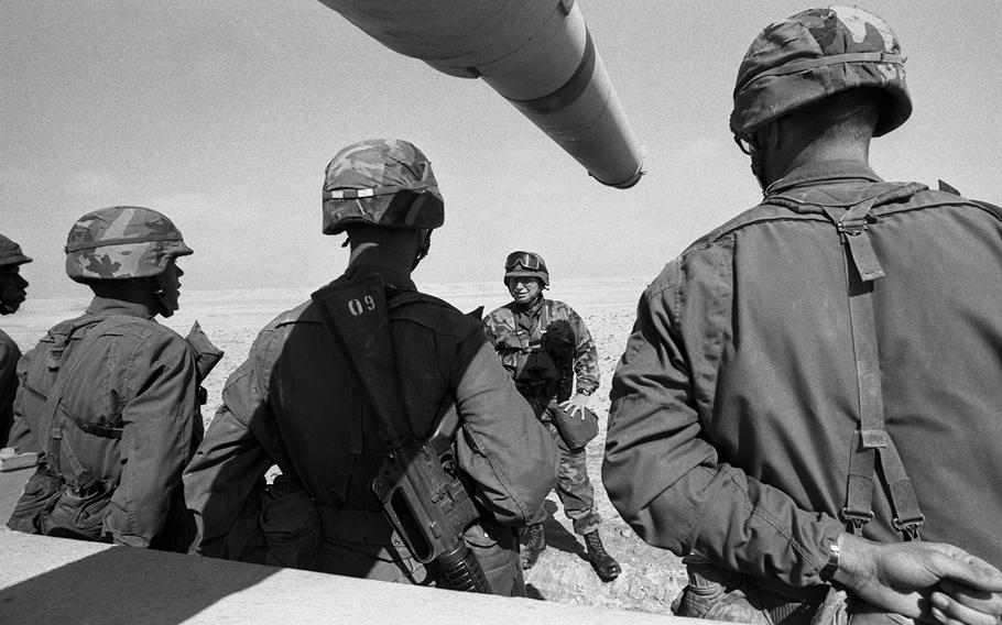 Soldiers from the 2nd Armored Cavalry Regiment receive a briefing on the battle scenario on the way toward Kuwait City in February, 1991.