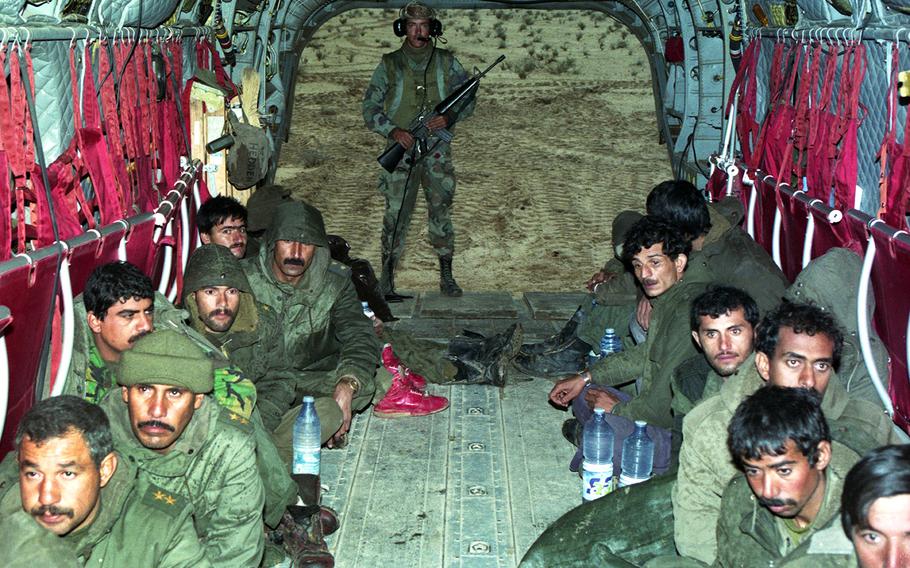 Iraqi soldiers sit in a U.S. helicopter after being taken prisoner in the early stages of the Gulf War in 1991.