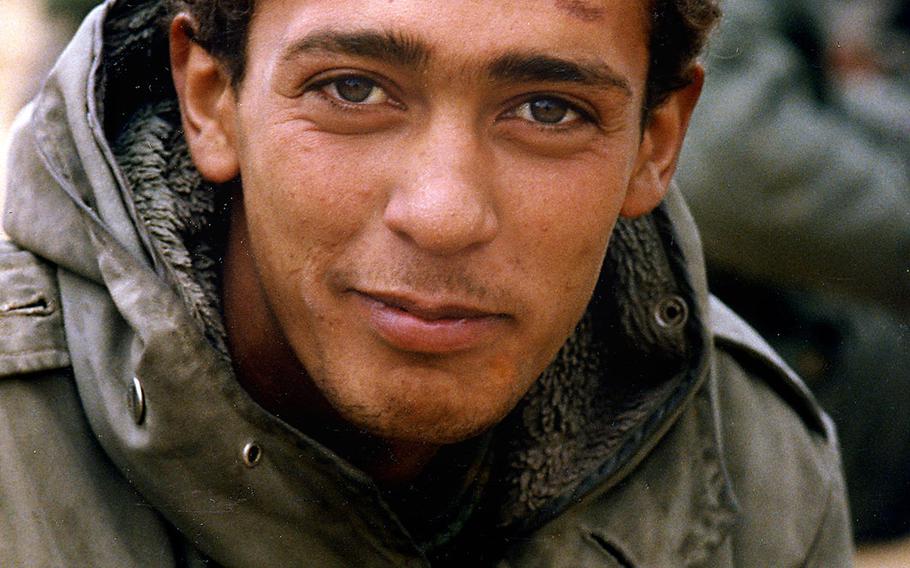 An Iraqi soldier captured by American soldiers from the 2nd Armored Cavalry Regiment during the Battle of 73 Easting in February, 1991 poses for a photo. The Army had asked that POWs not be photographed, but many wanted their pictures taken and published so that their families would know they were alive.