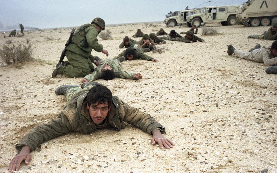 Iraqi prisoners of war are checked after their surrender to American troops from Iron Troop, 2nd Armored Cavalry Regiment in February, 1991.