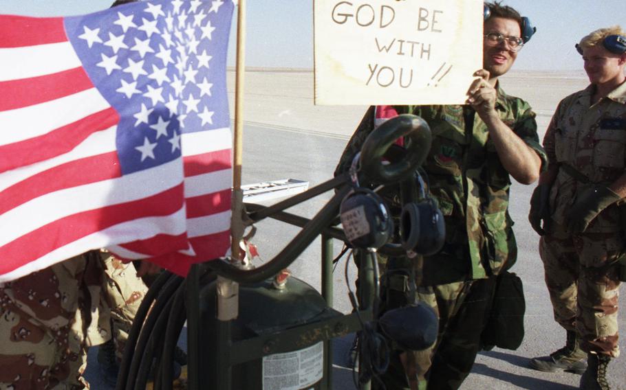 Weapons specialists from the 4th Tactical Fighter Wing (Provisional) in central Saudi Arabia show their support for pilots taking off on missions against Iraqi forces on the second day of the Gulf War's air campaign in January, 1991.