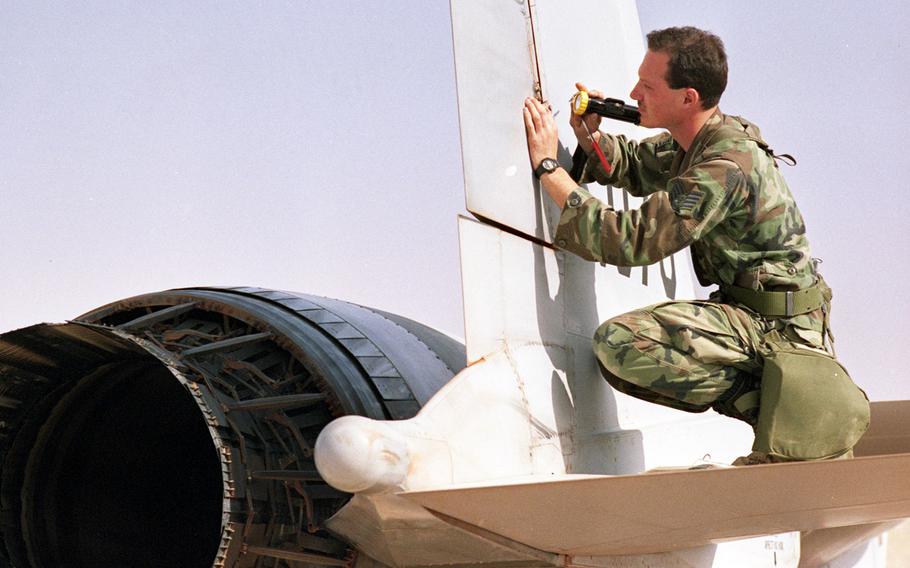 A plane gets a close inspection in January, 1990 at a base in central Saudi Arabia, where missions against Iraqi forces were under way on the second day of the Gulf War's air campaign.
