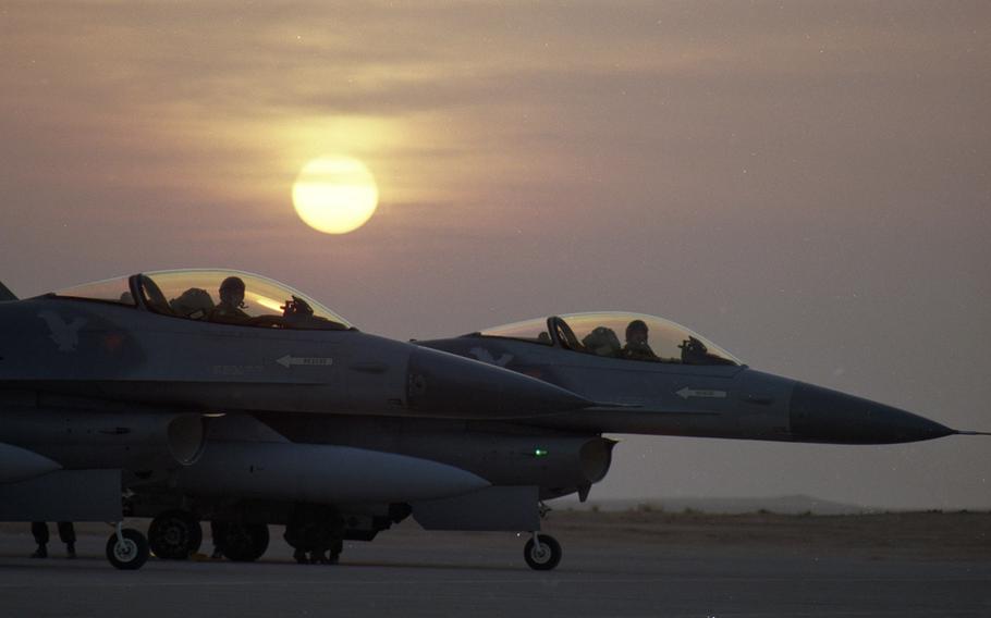 At a base in the Saudi Arabian desert in January, 1991, American pilots wait to take off on a mission against Iraqi forces in the early stages of Operation Desert Storm.