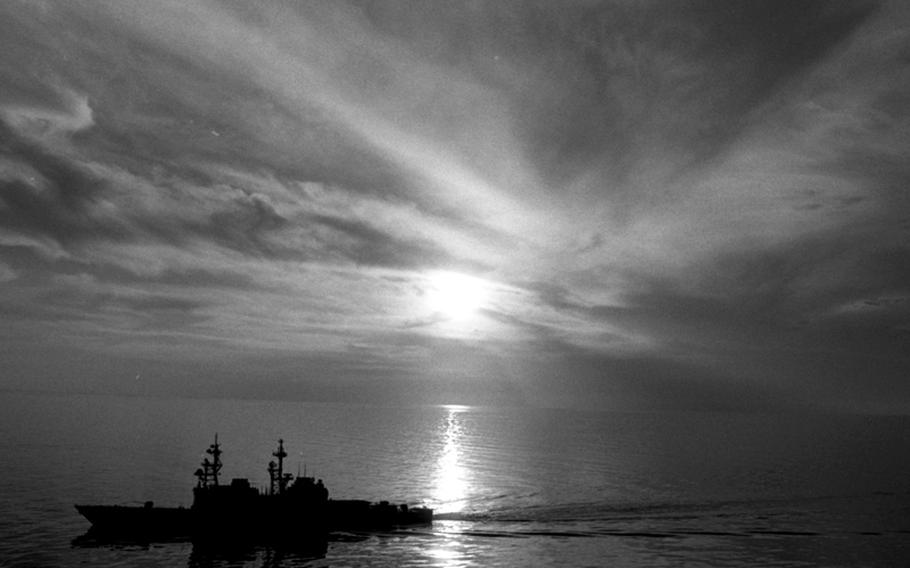 The USS Fife is silhouetted against the sun as it patrols the Gulf of Oman during Operation Desert Shield in December, 1990. When the Gulf War broke out the following month, the Yokosuka-based, Spruance-class destroyer fired Tomahawk missiles at targets in Iraq.