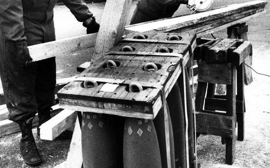 At Muenster, Germany, in November, 1990, Pvt. Dondi Holsey and Spec. Tom Cicione of the 184th Ordnance Company at Muenster Army Depot cut lumber to be used as shipping braces for 155mm howitzer ammunition on its way to the Middle East during Operation Desert Shield.