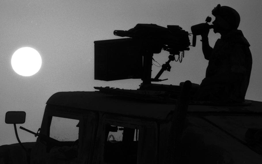 A U.S. Marine takes a water break in the Saudi Arabian desert ij October, 1990, during the buildup that led to the 1991 Gulf War.