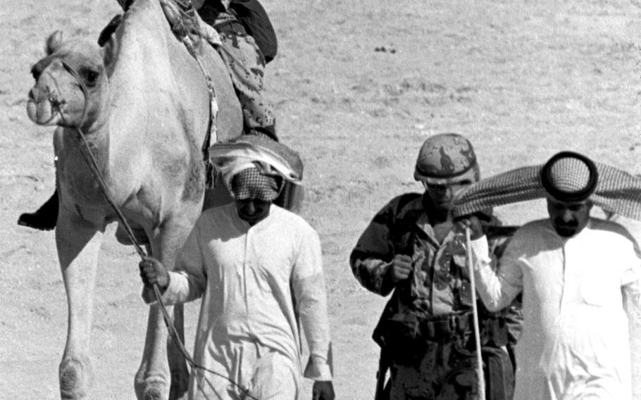 A servicemember deployed to Saudi Arabia during Operation Desert Shield tries out a traditional local means of transportation.