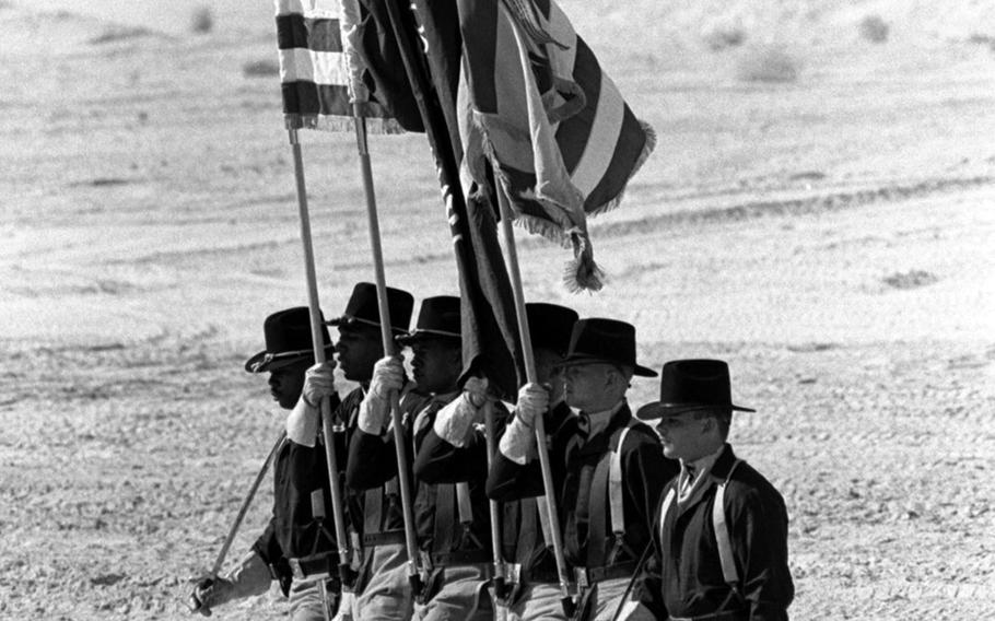 Members of the 1st Cavalry Division's support command present the colors at a change-of-command ceremony in Saudi Arabia in October, 1990. Col. Richard J. Fousek replaced Col. Harold E. Burch as commander of the Fort Hood, Texas-based troops, who were taking part in Operation Desert Shield.