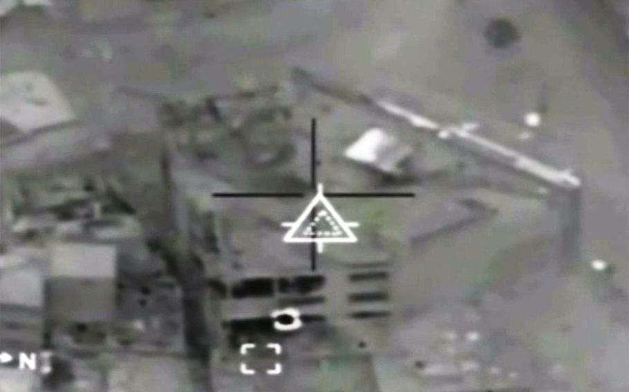 In a scene from a Combined Joint Task Force video, an Islamic State headquarters and financial facility at Mosul, Iraq, is targeted seconds before its destruction in a coalition airstrike.