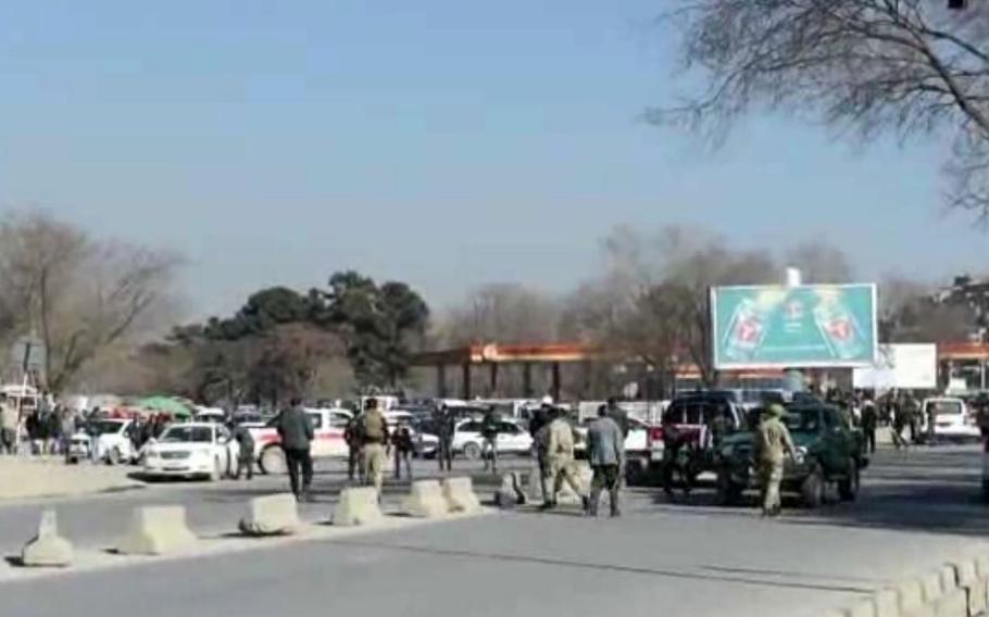 In this video still image, authorities assess the damage at the blast scene which occurred at the entrance of the National Civil Order Police in western Kabul, Najeed Danish, an Interior Ministry spokesman said.