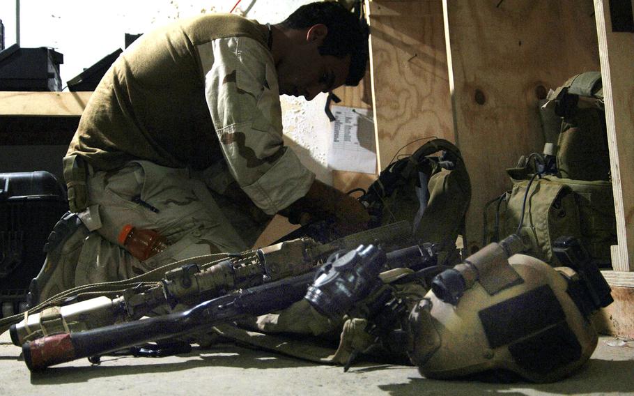 In a 2007 file photo, a U.S. Special Operations Forces member prepares his gear for an evening mission in western Iraq.