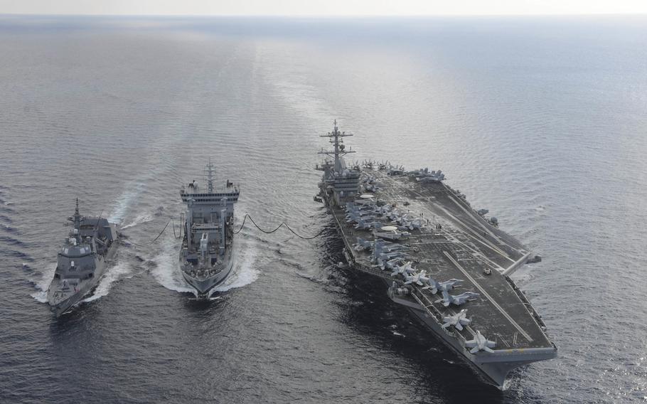 The USS Theodore Roosevelt, right, and Japanese Maritime Self-defense Force JS Fuyuzuki, center, transit alongside the Indian tanker INS Shakti during a replenishment-at-sea exercise Oct. 18, 2015, in the Indian Ocean. Japan should consider sending ships to the South China Sea to join U.S. freedom-of-navigation efforts there, a Japan defense expert said Thursday.